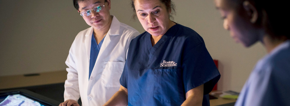 Three doctors in blue Boston Scientific scrubs