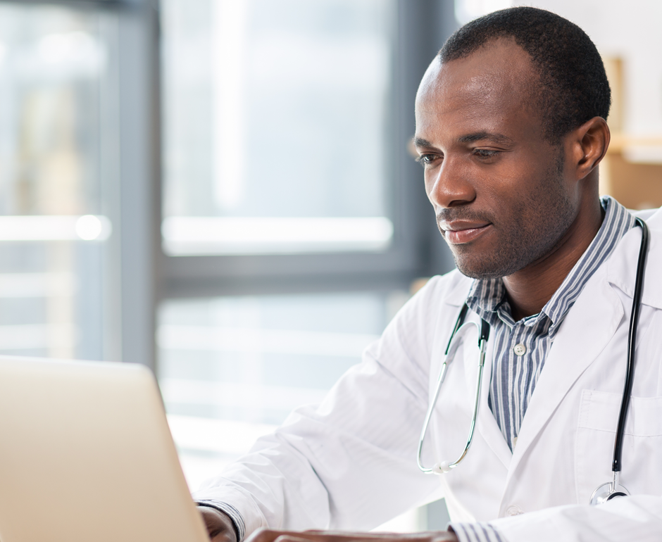 A clinician uses a laptop