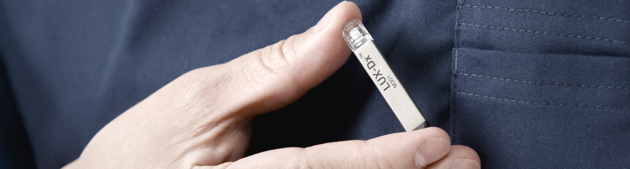 Hand holding LUX-Dx Insertable Cardiac Monitor System from Boston Scientific